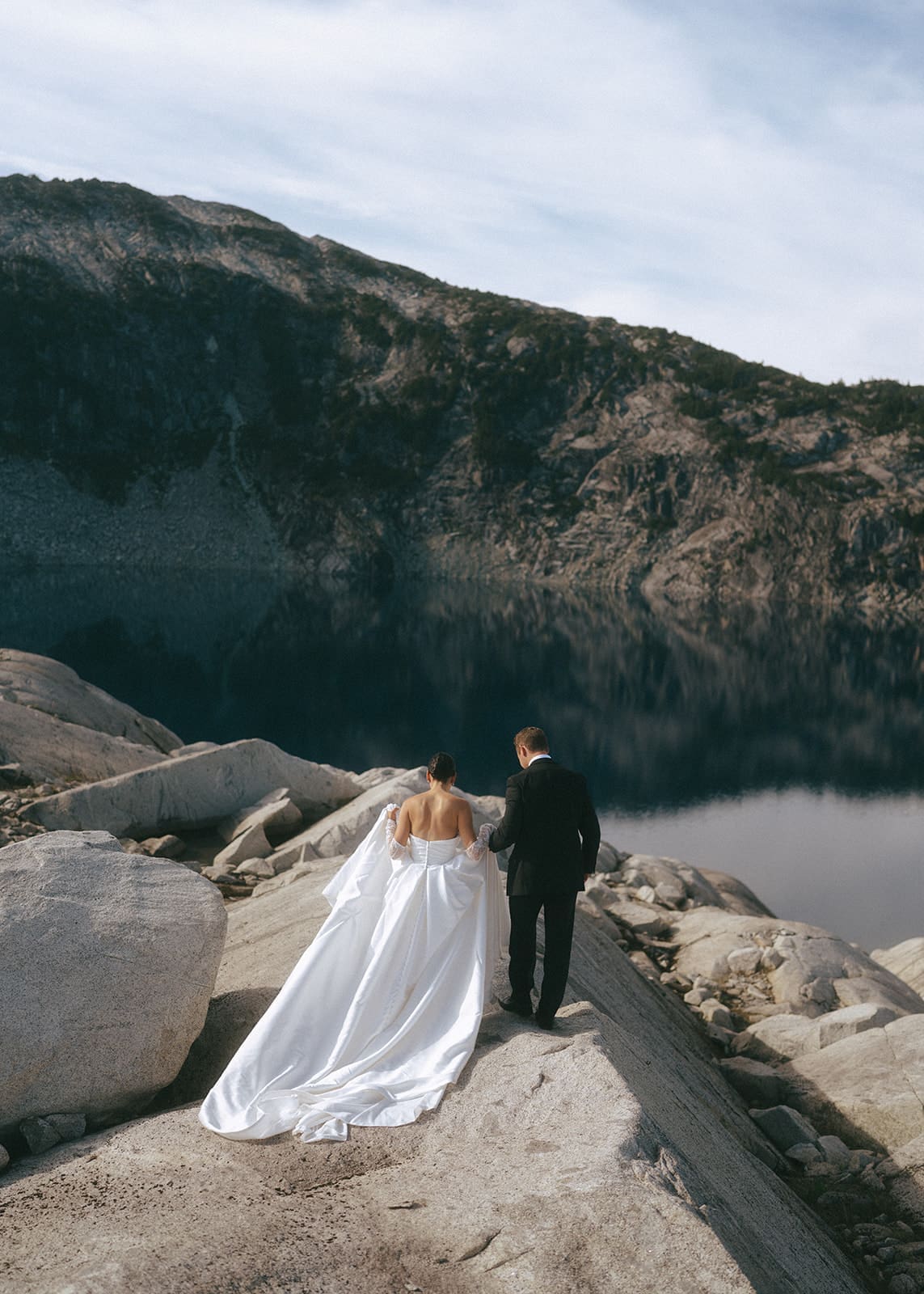 bride and groom walking away on rocky mountain on Vancouver Island