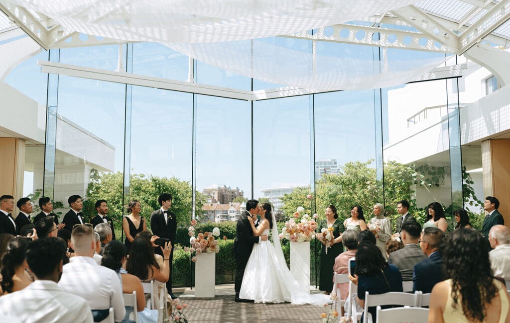 couple kissing after just getting married during their ceremony