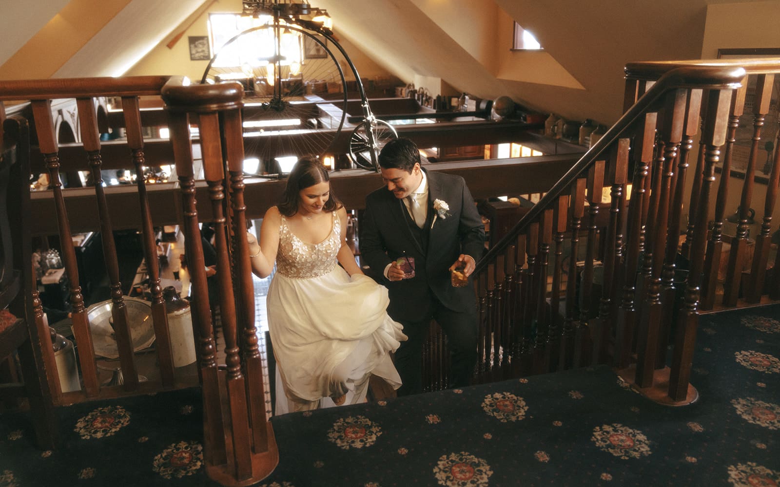 wedding couple walking up the stairs inside the penny farthing pub