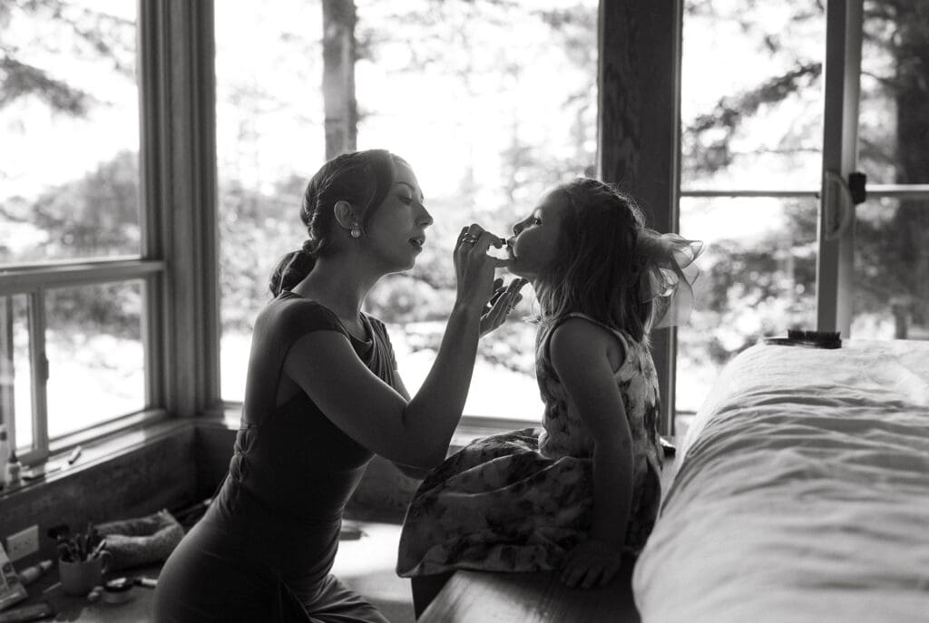 Guests get ready for a beachside elopement in this black and white photo taken at pacific sands beach resort tofino british columbia