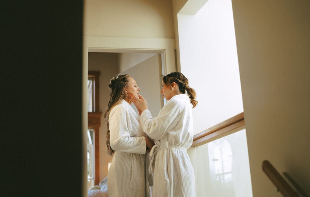 A bride gets dressed for her wedding day in this photo taken before an elopement held at pacific sands beach resort tofino british columbia