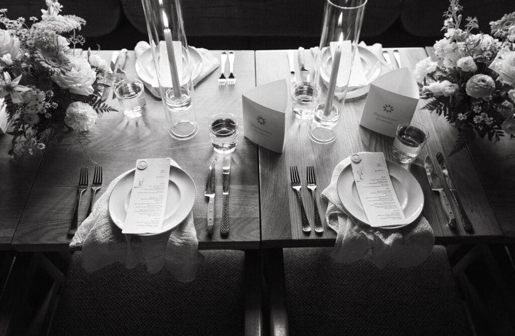 A Banff wedding reception table scape is shown in a black and white photo 