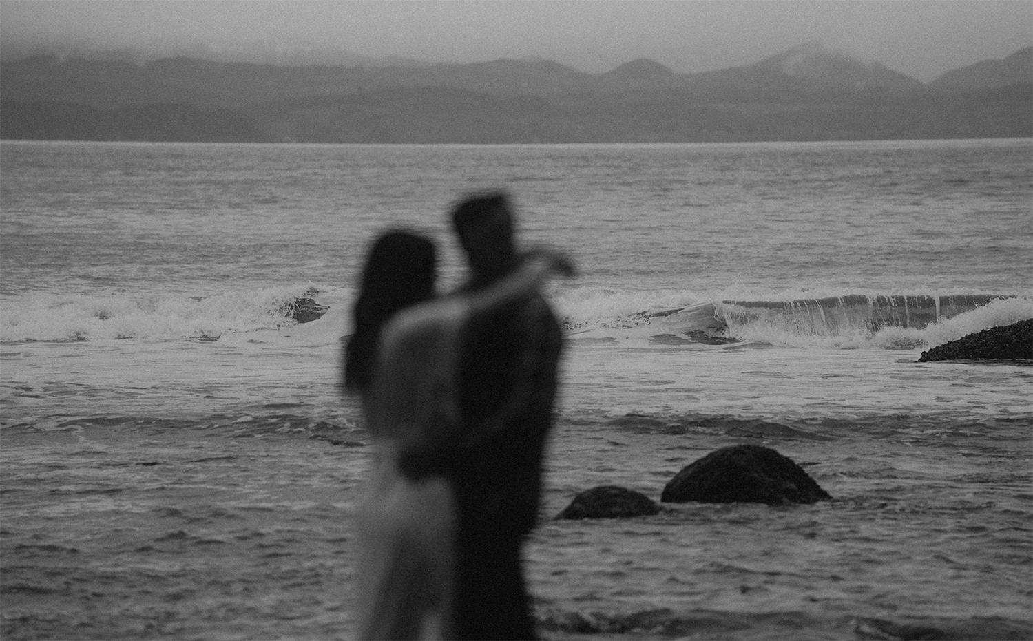 A couple embrace during engagement photos vancouver island taken at Jordan River Regional Park 