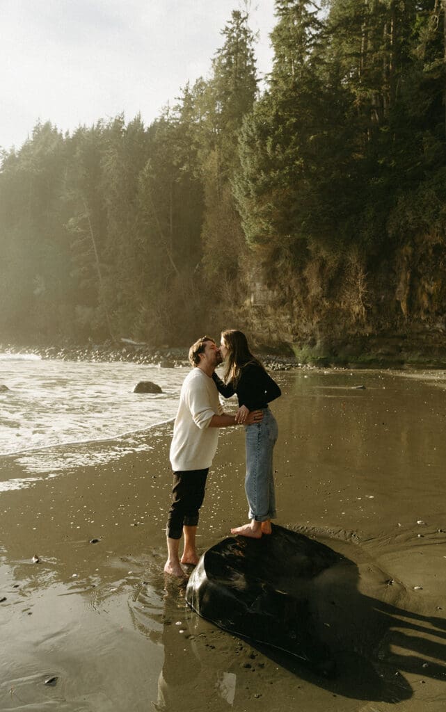 A couple share a kiss in engagement photos vancouver island