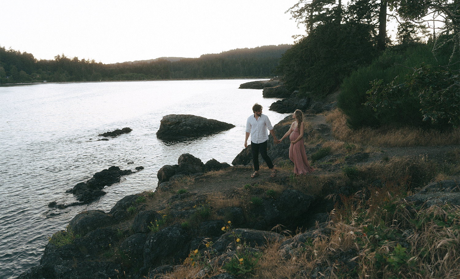 couple exploring best vancouver island location for engagement photos by the beach
