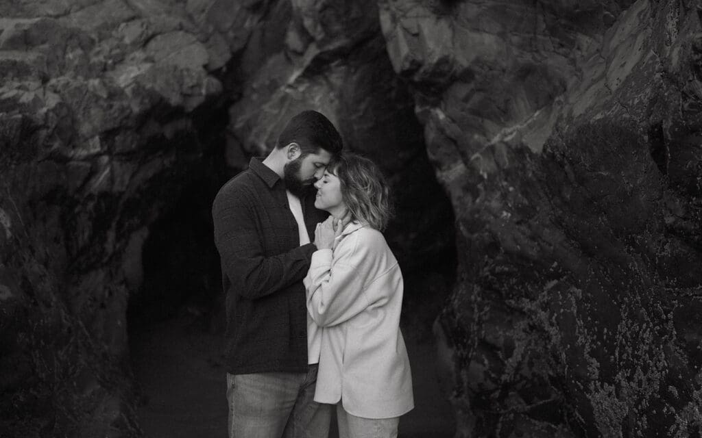 A couple embraces at Tonquin Beach during engagement photos vancouver