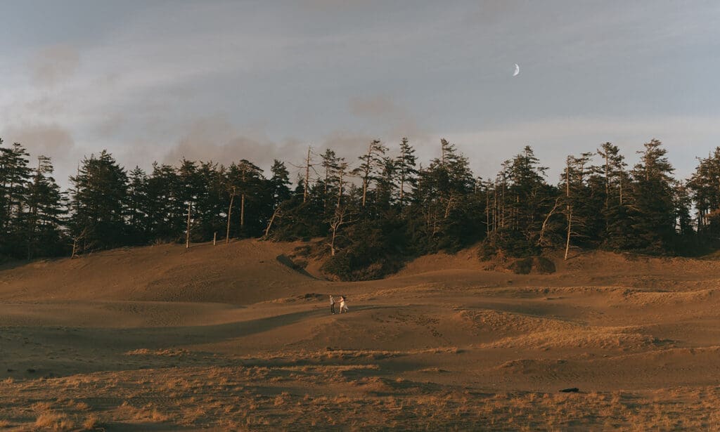 An engaged couple run hand-in-hand along Tonquin Beach during engagement photos vancouver island
