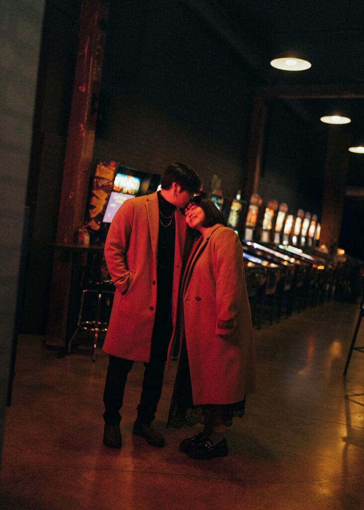 A couple embrace on the streets of Victoria during an engagement photoshoot on vancouver island