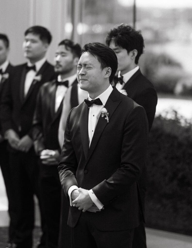 A groom has an emotional reaction to seeing his bride at their laurel point inn wedding
