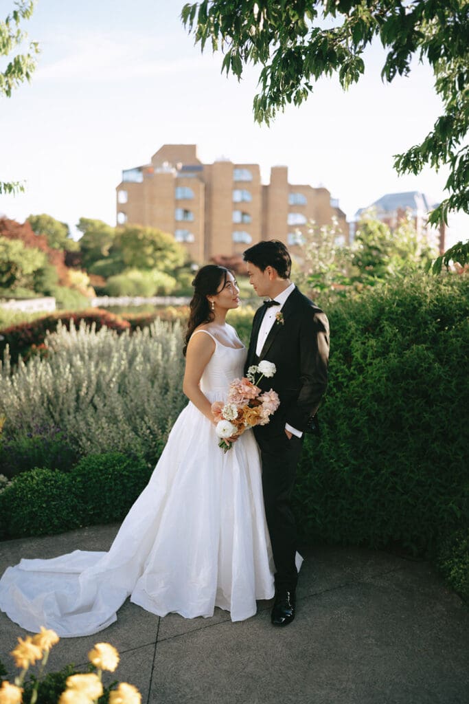 A bride and groom pose for a bridal portrait in Downtown Victoria following their laurel point inn wedding