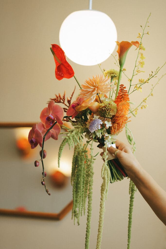 A colorful bridal bouquet is photographed at a retro inspired Hatley Castle wedding