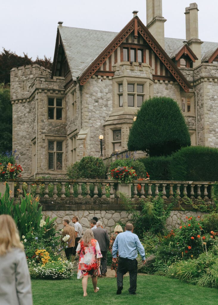 Wedding guests walk on the lawn at a Hatley Castle wedding 